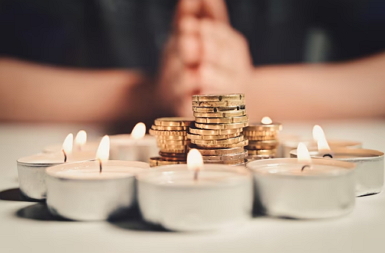 manifesting money header image of coins and candles
